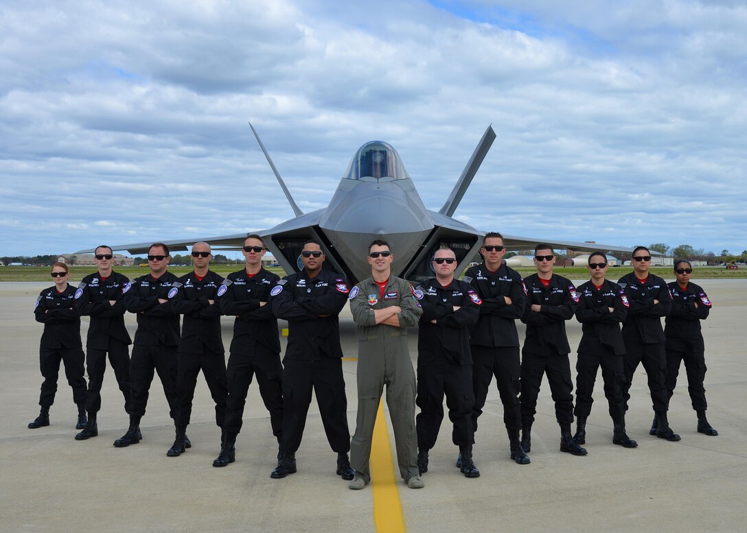 F-22 Raptor Demonstration Team pose for photo in front of an F-22 Raptor