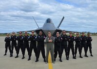 F-22 Raptor Demonstration Team pose for photo in front of an F-22 Raptor