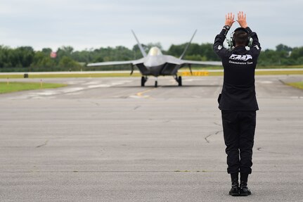 Crew chief recovers F-22 Raptor on flightline.