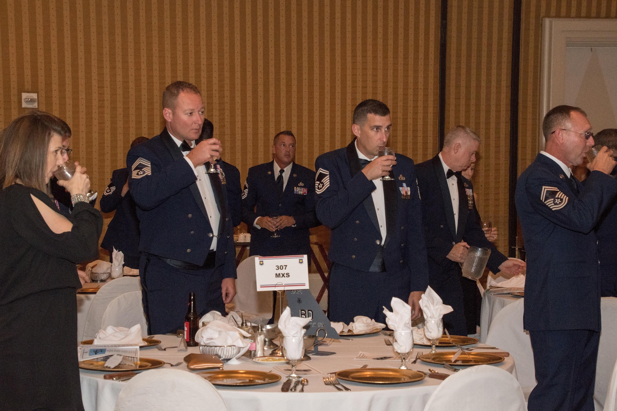 Airmen drink after a ceremonial toast to open the 307th Bomb Wing Senior Noncommissioned Officer Induction and Chief Recognition Ceremony in Shreveport, La., Nov. 4, 2017.