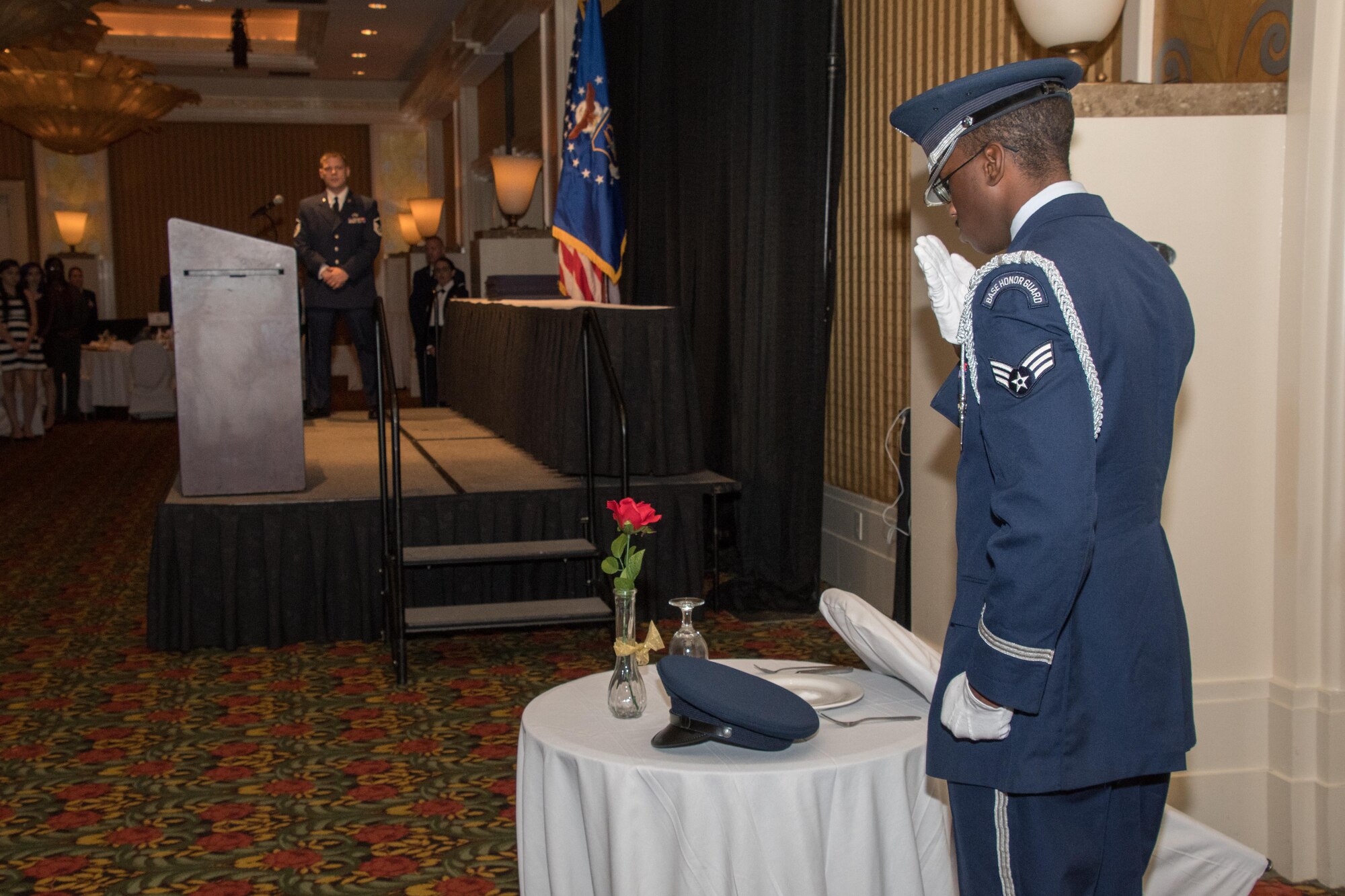 An Airman from the Barksdale Air Force Base Honor Guard salutes the POW/MIA Table during the 307th Bomb Wing Senior Noncommissioned Officer Induction and Chief Recognition Ceremony in Shreveport, La. Nov. 4, 2017.