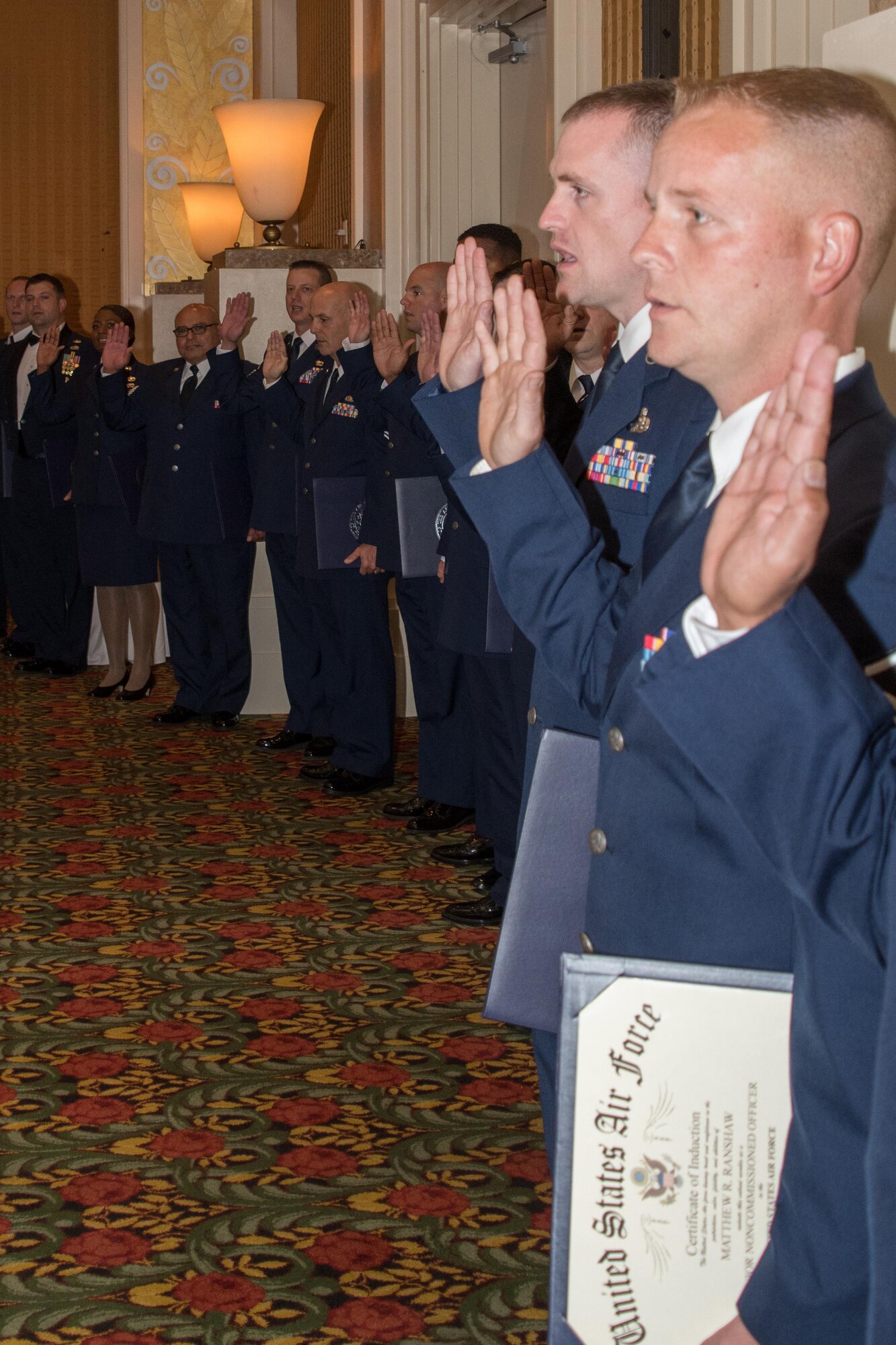 A long line of Airmen take an oath of service as newly inducted senior non-commissioned officers during the 307th Bomb Wing Senior Noncommissioned Officer Induction and Chief Recognition Ceremony in Shreveport, La. Nov. 4, 2017.
