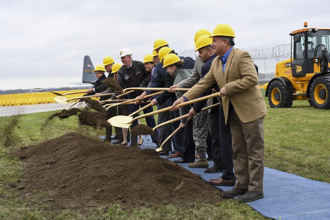 Sharon Raque, representing the Army Corps of Engineers; Vince Gastgeb, the vice president of government and community affairs with Allegheny County Airport Authority; Elizabeth Fishback, representing Senator Robert Casey’s office; Col. Jeff VanDootingh, commander of the 911th Airlift Wing; Lt. Governor of Pennsylvania Michael Stack, Doug Keeter; representing the Pittsburgh Airport Area Chamber of Commerce, James Plante; representing Senator Patrick Toomey’s office, Joseph Wiedner; representing Congressman Keith Rothfus’ office; the 911th Airlift Wing’s newest Airman; Ben Logan, president of Carothers Construction; John Devere, senior project manager with Walsh Group; and Chris Mathies, vice president of operations with NOVA Group, take the first of many shovelfuls of dirt at the C-17 Conversion Groundbreaking Ceremony at the Pittsburgh International Airport Air Reserve Station, Pa., November 7, 2017. The ceremony signifies the beginning of construction that will make the base capable of housing a fleet of C-17 Globemaster III aircraft, replacing its current fleet of C-130 Hercules as well as bringing a new mission to the base. (U.S. Air Force photo by Senior Airman Beth Kobily)