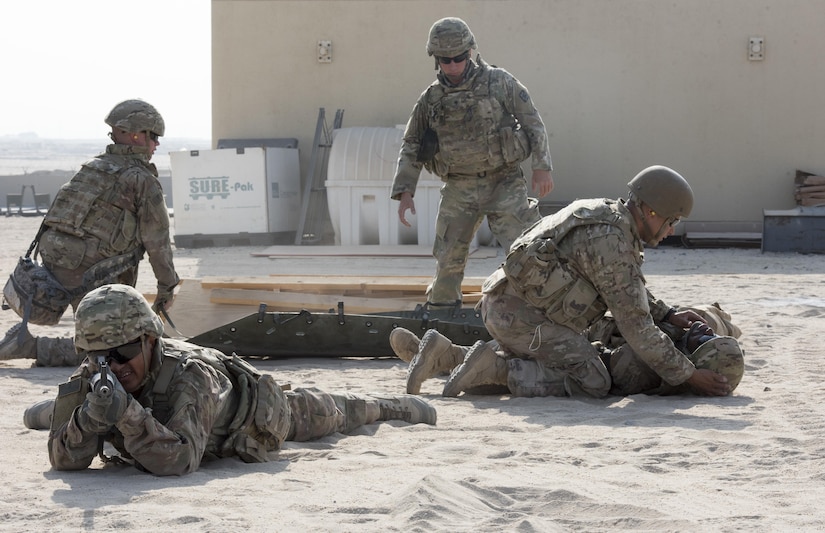 Soldiers practice loading another Soldier onto a litter.