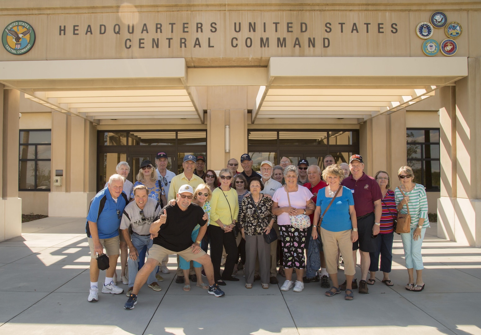 Marines of Marine Attack Squadron (VMA) 225 and spouses pose for a photo following a tour at U.S. Central Command headquarters, November 3, 2017. (Department of Defense photo by Tom Gagnier)