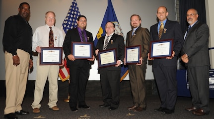 IMAGE: DAHLGREN, Va. (Nov. 1, 2017) - Five recipients of the Secretary of Defense Medal for the Global War on Terrorism (GWOT) Medal are flanked by Naval Surface Warfare Center Dahlgren Division (NSWCDD) Commanding Officer Capt. Godfrey 'Gus' Weekes and NSWCDD Technical Director John Fiore at a ceremony held at the command's leadership meeting. The GWOT Medal was presented to the NSWC Dahlgren employees to recognize and honor their contributions and accomplishments in direct support of the armed forces engaged in operations to combat terrorism. Standing left to right are: Weekes, Daniel Carlyle, Cameron Sorlie, Andrew Davis, Jeremiah Lange, Matthew Vaerewyck, and Fiore.