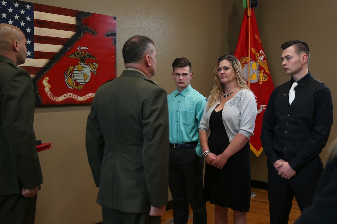 U.S. Marine Brig. Gen. Kurt W. Stein (center left), Director of Marine and Family Programs, Manpower and Reserve Affairs, presents Silver Star to Lance Cpl. Donald J. Cline’s wife, Tina Cline (center right) and sons Dylan Cline (left) and Dakota Cline (right), during the Silver Star Award ceremony in his honor on Marine Corps League Detachment 1419, Mandan, North Dakota, Nov 1, 2017.