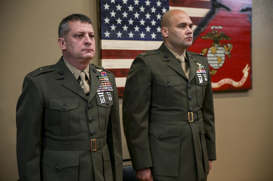 U.S. Marine Brig. Gen. Kurt W. Stein, Director of Marine and Family Programs, Manpower and Reserve Affairs, stands at attention alongside Captain Shaun R. Locklear, Inspector – Instructor of Military Police Support Company, 4th Law Enforcement Battalion during Silver Star Award ceremony in honor of Lance Cpl. Donald J. Cline on Marine Corps League Detachment 1419, Mandan, North Dakota, Nov 1, 2017.