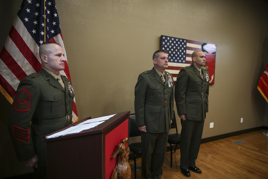 U.S. Marine Brig. Gen. Kurt W. Stein, Director, Marine and Family Programs, Manpower and Reserve Affairs, stands at attention alongside Captain Shaun R. Locklear, Inspector – Instructor of Military Police Support Company, 4th Law Enforcement Battalion and 1st Sgt Richard S. Mostoller, Inspector-Instructor First Sergeant, Support Company, 4th Law Enforcement Battalion during a Silver Star Award ceremony in honor of Lance Cpl. Donald J. Cline on Marine Corps League Detachment 1419, Mandan, North Dakota, Nov 1, 2017.