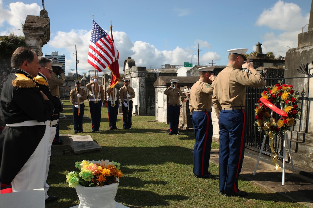 Marines with Marine Forces Reserve salute the gravesite of Marine Corps Maj. Daniel Carmick during the playing of taps at the St. Louis Cemetery No. 2 in New Orleans, Nov. 6, 2017.
