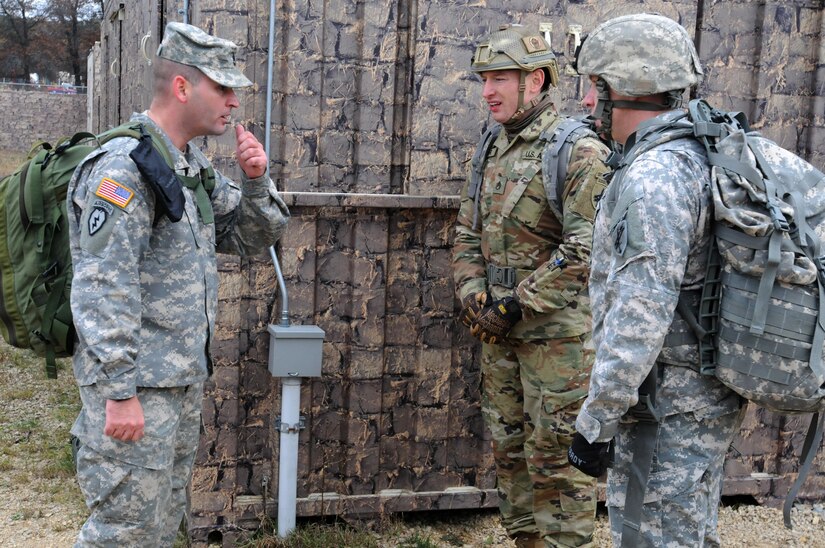 Sergeant 1st Class Nuhi Zhuta, left, from the 304th Civil Affairs Brigade, asks medical related questions to Staff Sgt. Loren Keeler, center, and Sgt. NAME Hardy, two best warrior competitors through some callisthenic exercises during the medical evaluation portion of the competition at Fort McCoy, Wisconsin, November 1, 2017.
(U.S. Army Reserve photo by Zach Mott, 88th Regional Support Command Public Affairs Office)