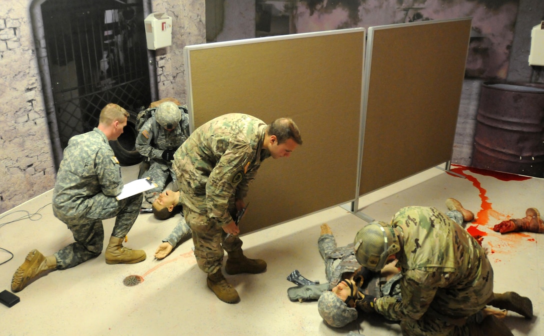 Best Warrior competitors Staff Sgt. Loren Keeler, right, and Sgt. Thomas Hardy, assess and treats a simulated casualty under the watchful eyes of judges Sgt. Brian Duckworth, right, and Staff Sgt. Dave Schulz, during the competition conducted by 353rd Civil Affairs Command at Fort McCoy, Wisconsin, November 1, 2017. Keeler went on to win the title of 353rd CACOM 2017 Non-Commissioned Officer of the Year.
(U.S. Army Reserve photo by Zach Mott, 88th Regional Support Command Public Affairs Office)