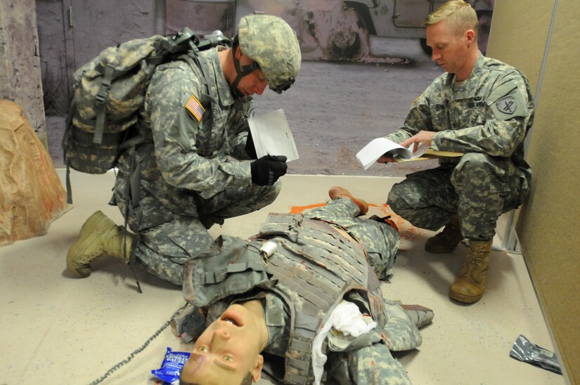 Sergeant Thomas Hardy, from 418th Civil Affairs Battalion, prepares to call in the nine-line MEDEVAC notification while Staff Sgt. Dave Schulz, from the 432nd Civil Affairs Battalion, assesses Hardy’s performance during the 353rd Civil Affairs Command Best Warrior Competition at Fort McCoy, Wisconsin, November 1, 2017.
(U.S. Army Reserve photo by Zach Mott, 88th Regional Support Command Public Affairs Office)