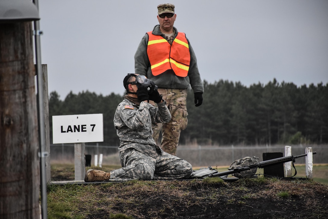 Sergeant Dyami Kellyclark, 443rd Civil Affairs Battalion, dons his gas mask on the M16 range at the 353rd Civil Affairs Command Best Warrior Competition at Fort McCoy, Wisconsin, November 2, 2017. 
(U.S. Army Reserve photo by Catherine Lowrey, 88th Regional Support Command Public Affairs Office)