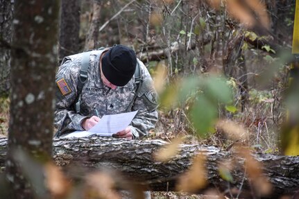 Sergeant Thomas Hardy, from 418th Civil Affairs Battalion, plots grid coordinates during the Land Navigation Course at the 353rd Civil Affairs Command Best Warrior Competition at Fort McCoy, Wisconsin, November 3, 2017.
(U.S. Army Reserve photo by Catherine Lowrey, 88th Regional Support Command Public Affairs Office)
