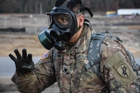 Specialist Pedro Benavides, from 407th Civil Affairs Battalion, wears his gas mask during the 353rd Civil Affairs Command Best Warrior Competition at Fort McCoy, Wisconsin, November 3, 2017.
(U.S. Army Reserve photo by Catherine Lowrey, 88th Regional Support Command Public Affairs Office)