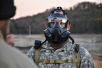 Sergeant Dyami Kellyclark, 443rd Civil Affairs Battalion, dons his gas mask during the Army Warrior Task lanes at the 353rd Civil Affairs Command Best Warrior Competition at Fort McCoy, Wisconsin, November 3, 2017.
(U.S. Army Reserve photo by Catherine Lowrey, 88th Regional Support Command Public Affairs Office)
