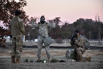 Staff Sgt. Loren Keeler, 407th Civil Affairs Battalion, and Spc. Pedro Benavides, from 407th Civil Affairs Battalion, don their gas masks during the Army Warrior Task lanes while participating in the 353rd Civil Affairs Command Best Warrior Competition at Fort McCoy, Wisconsin, November 3, 2017.
(U.S. Army Reserve photo by Catherine Lowrey, 88th Regional Support Command Public Affairs Office)