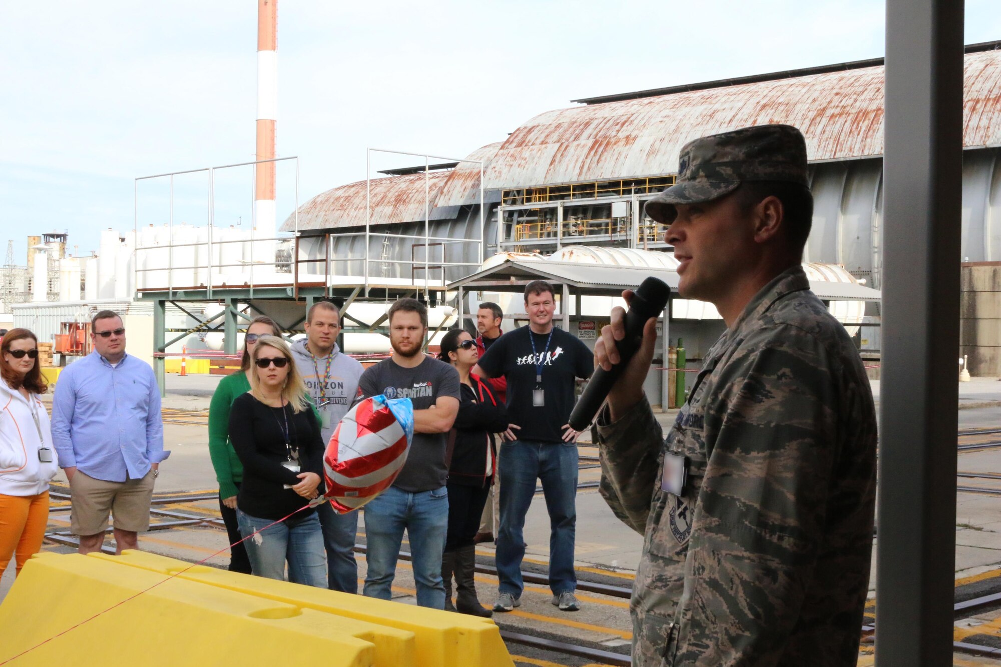 Lt. Col. David Hoffman addresses attendees of the Oct. 21 Flight Systems Combined Test Force open house event. The Flight Systems CTF at AEDC offers aerodynamic ground-test capabilities from very low subsonic speeds through Mach number 10 in various wind tunnels. These tunnels provide essential test and analysis services in support of DOD, national, U.S. industry and international space programs. (U.S. Air Force photo/Bradley Hicks) (This image was manipulated by obscuring badges for security purposes.)