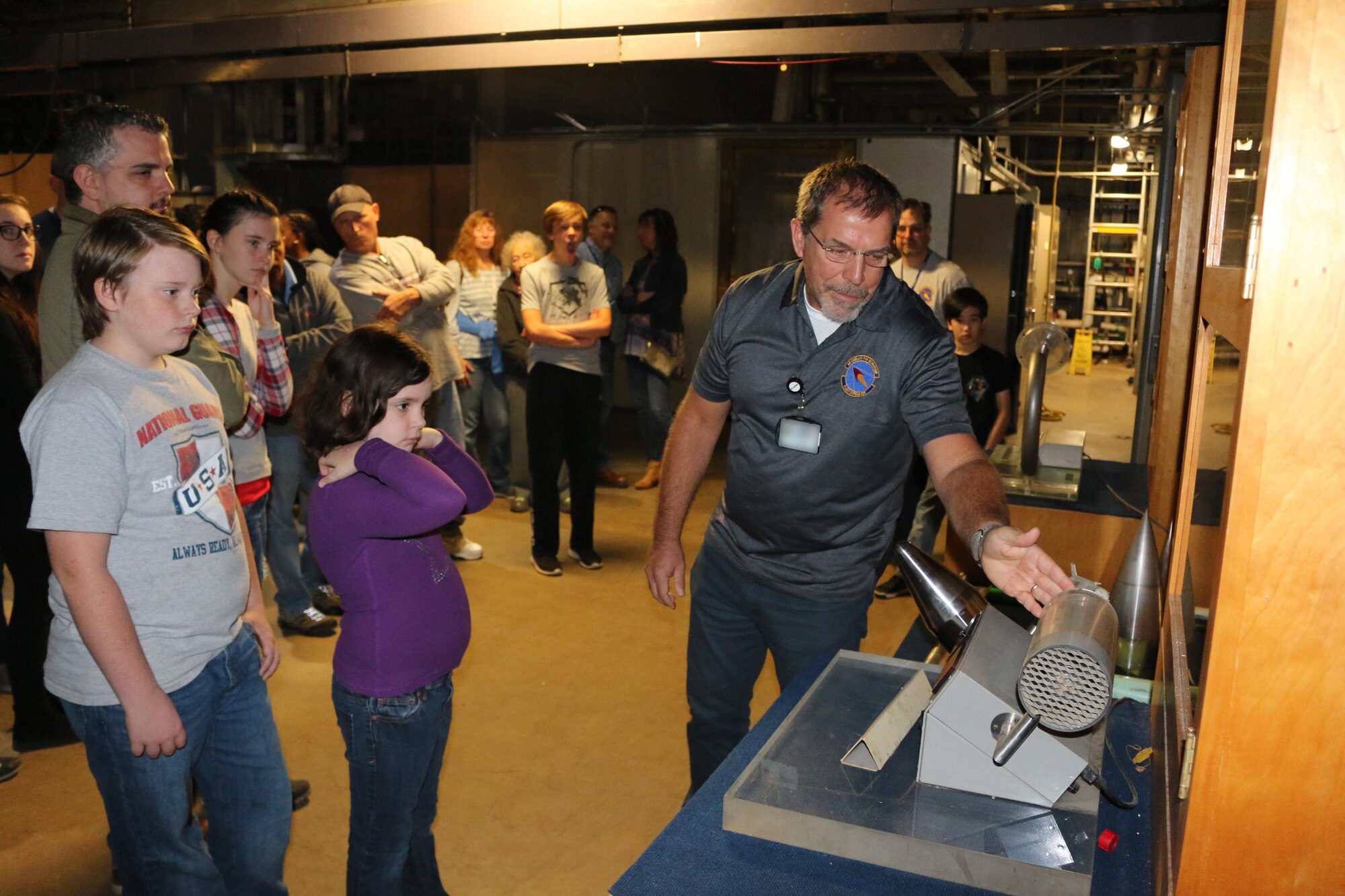 John Hopf speaks about a heat transfer simulation model at the von Kàrmàn Gas Dynamics Facility during the Flight Systems Combined Test Force open house Oct. 21. The Flight Systems CTF at AEDC offers aerodynamic ground-test capabilities from very low subsonic speeds through Mach number 10 in various wind tunnels. These tunnels provide essential test and analysis services in support of DOD, national, U.S. industry and international space programs. (U.S. Air Force photo/Bradley Hicks) (This image was manipulated by obscuring badges for security purposes.)