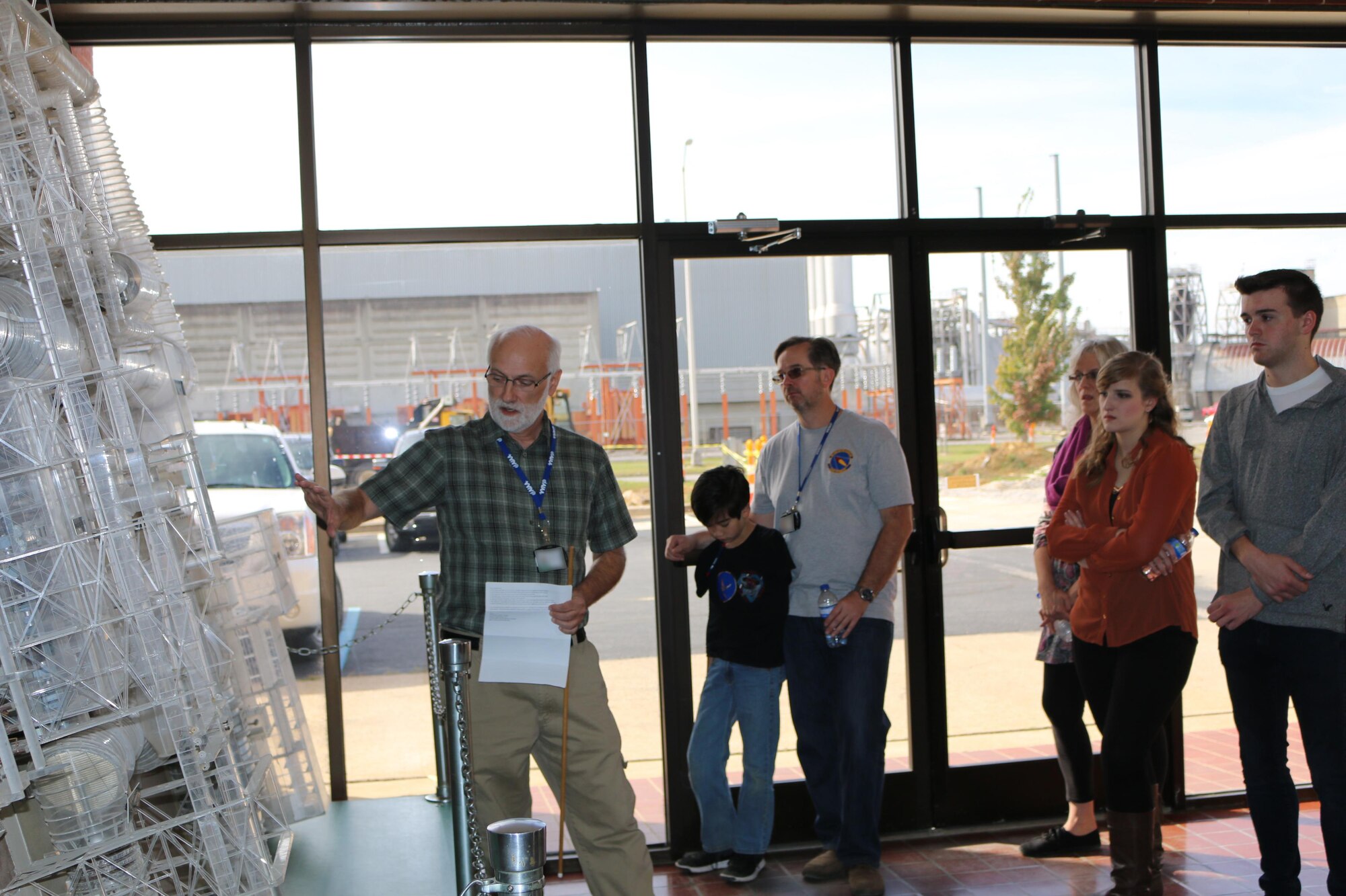 Mike Mills, AEDC Fellow, discusses the Propulsion Wind Tunnel lobby model during the Flight Systems Combined Test Force open house event Oct. 21. The Flight Systems CTF at AEDC offers aerodynamic ground-test capabilities from very low subsonic speeds through Mach number 10 in various wind tunnels. These tunnels provide essential test and analysis services in support of DOD, national, U.S. industry and international space programs. (U.S. Air Force photo/Bradley Hicks) (This image was manipulated by obscuring badges for security purposes.)