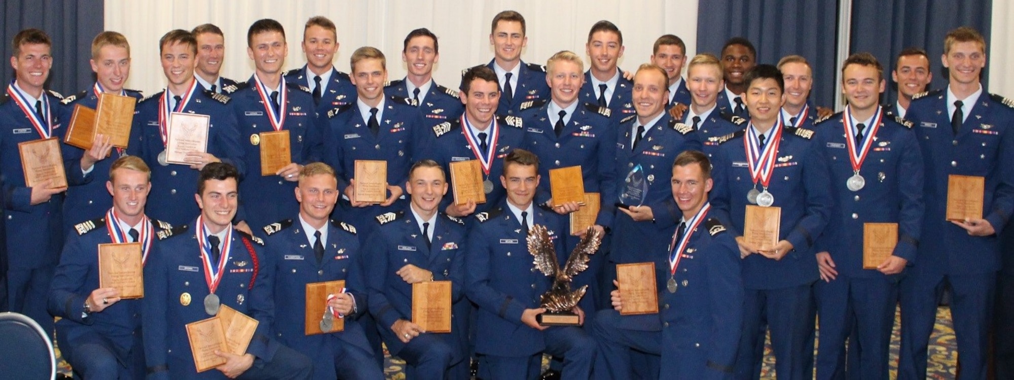 USAFA Flying Team National Intercollegiate Flying Association competition champions pose with their awards during the award ceremony. (U.S. Air Force photo by Tsali Bentley)