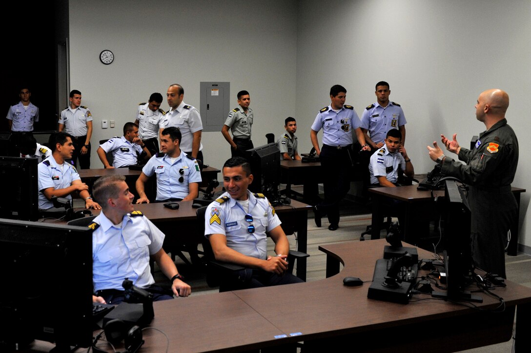 Maj. Adam Vogel, 56th Operations Group F-35 instructor pilot, instructs a class on how to fly an F-35A Lightning II on a desktop simulator at Luke Air Force Base, Ariz. Nov. 6, 2017. The Latin American Cadet’s Initiatives program toured through the U.S. for approximately three and a half weeks. (U.S. Air Force photo/Airman 1st Class Pedro Mota)