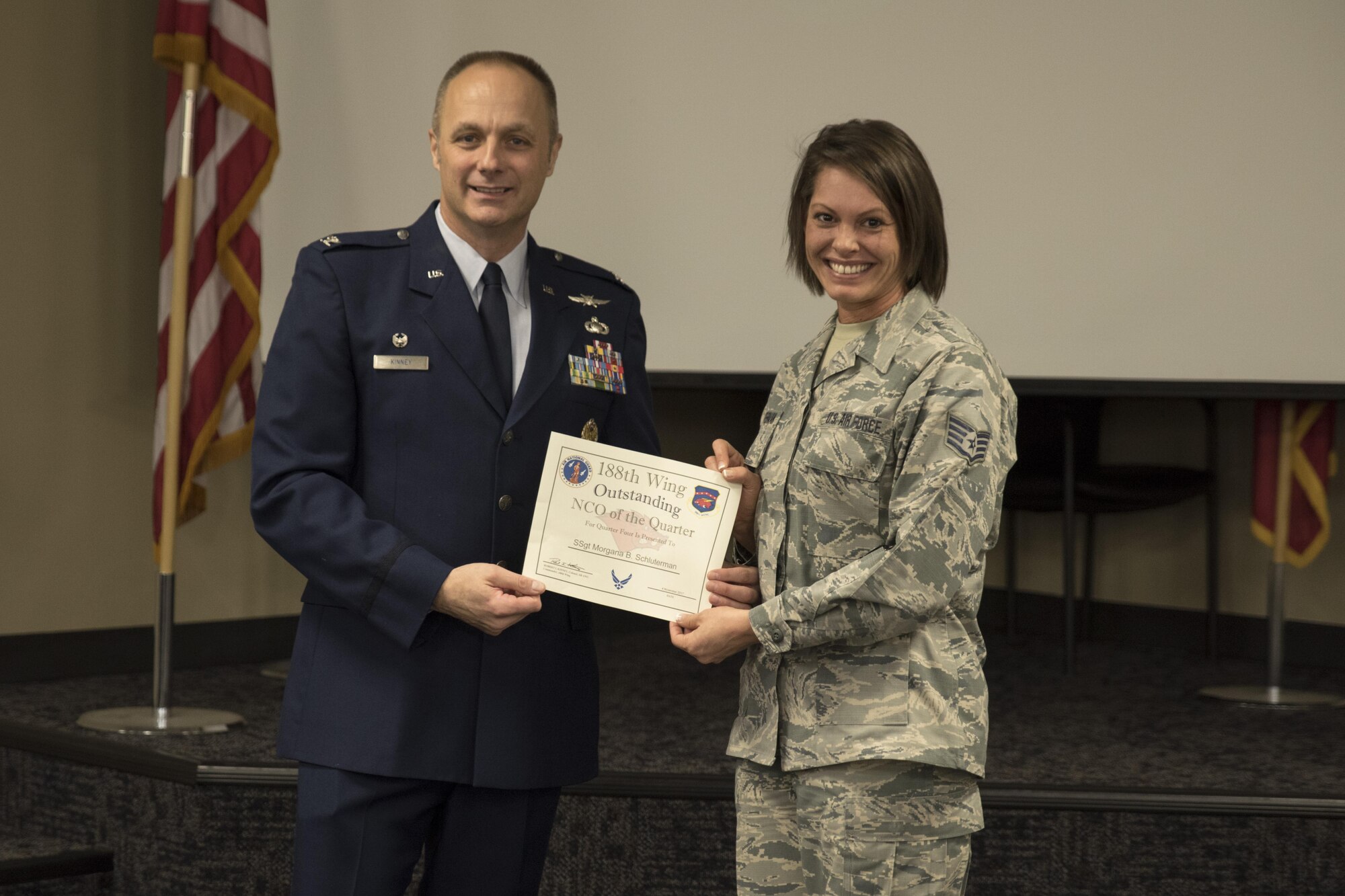 Staff Sgt. Morgana Schluterman, accepts the Noncommissioned officer of the Quarter award from Col. Robert Kinney, 188th Wing commander, Nov. 4, 2017, at Ebbing Air National Guard Base, Fort Smith, Ark. The award is given to airmen that have provided exceptional service to the wing throughout the last quarter and distinguished themselves among the best in the 188th. Winners were selected in the Airman, NCO, Senior NCO, First Sergeant, CGO and Field Grade Officer categories. (U.S. Air National Guard photo by Tech. Sgt. Daniel Condit)