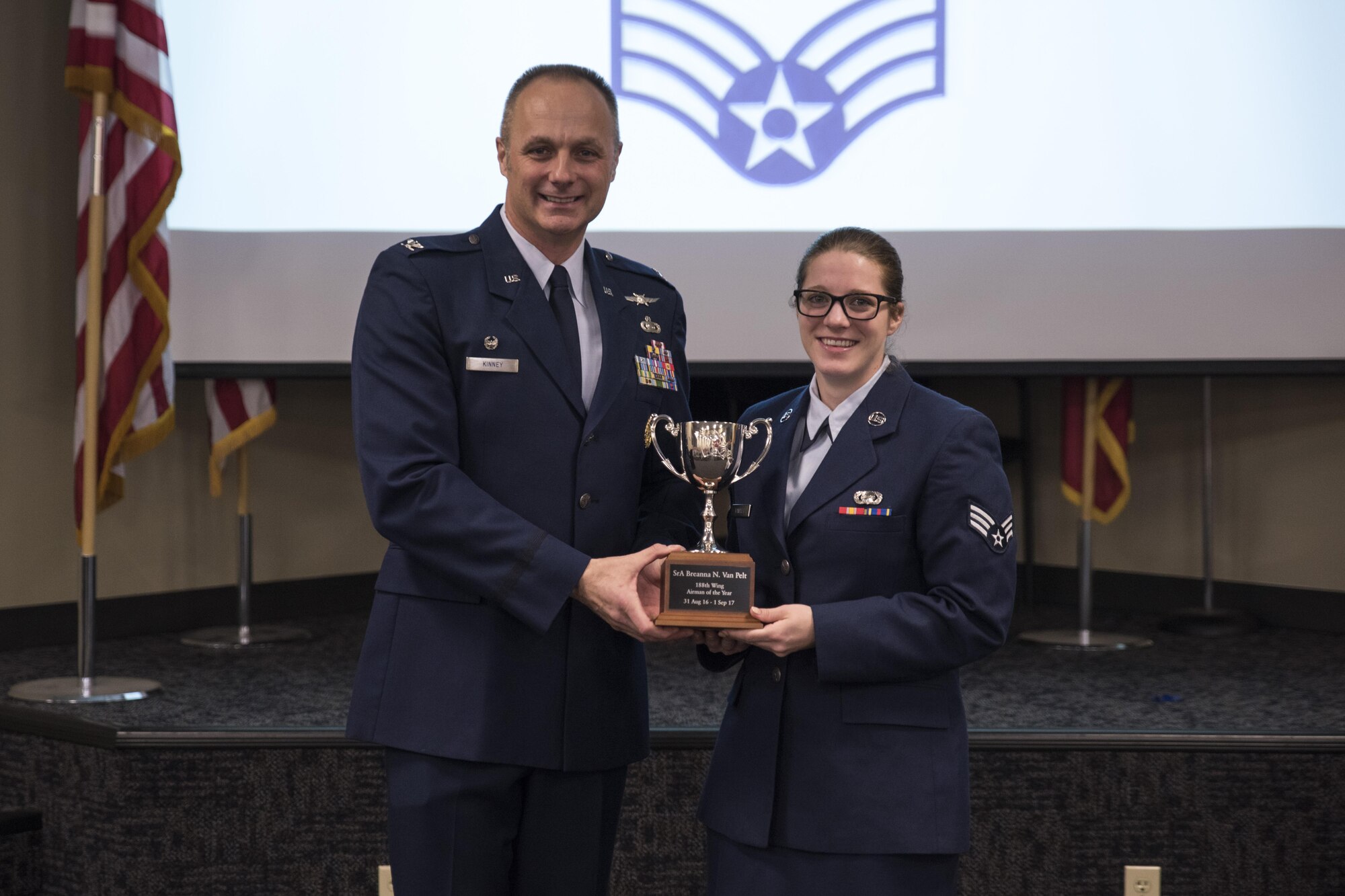 Senior Airman Breanna Van Pelt accepts the Airman of the Year award from Col. Robert Kinney, 188th Wing commander, Nov. 4, 2017, at Ebbing Air National Guard Base, Fort Smith, Ark. The award is given to airmen that have provided exceptional service to the wing throughout the last year and distinguished themselves among the best in the 188th. Winners were selected in the Airman, Noncommissioned Officer, Senior NCO, First Sergeant, CGO and Field Grade Officer categories. (U.S. Air National Guard photo by Tech. Sgt. Daniel Condit)
