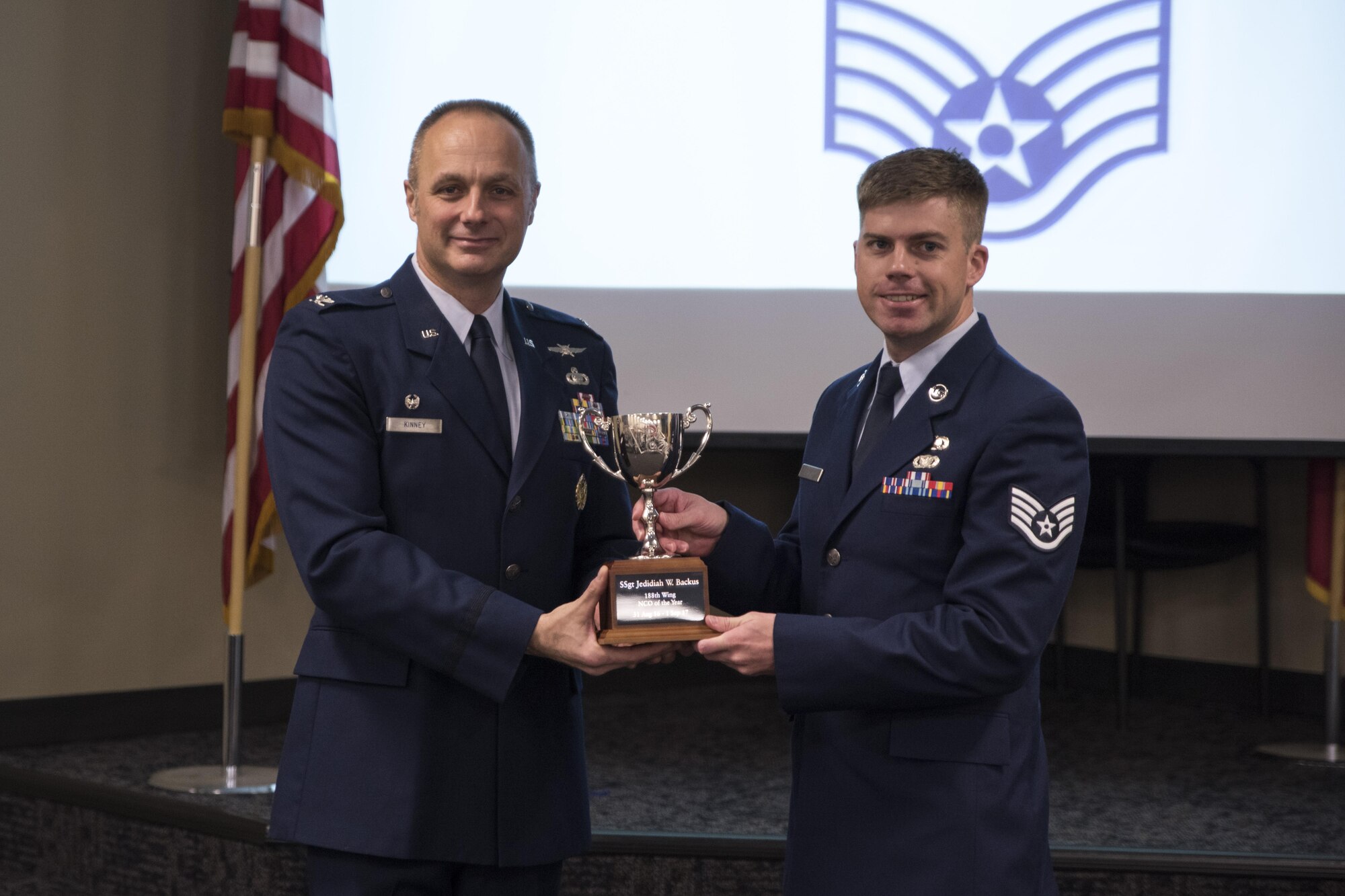 Staff Sgt. Jedidiah Backus accepts the Noncommissioned officer of the Year award from Col. Robert Kinney, 188th Wing commander, Nov. 4, 2017, at Ebbing Air National Guard Base, Fort Smith, Ark. The award is given to airmen that have provided exceptional service to the wing throughout the last year and distinguished themselves among the best in the 188th. Winners were selected in the Airman, Noncommissioned Officer, Senior NCO, First Sergeant, CGO and Field Grade Officer categories. (U.S. Air National Guard photo by Tech. Sgt. Daniel Condit)