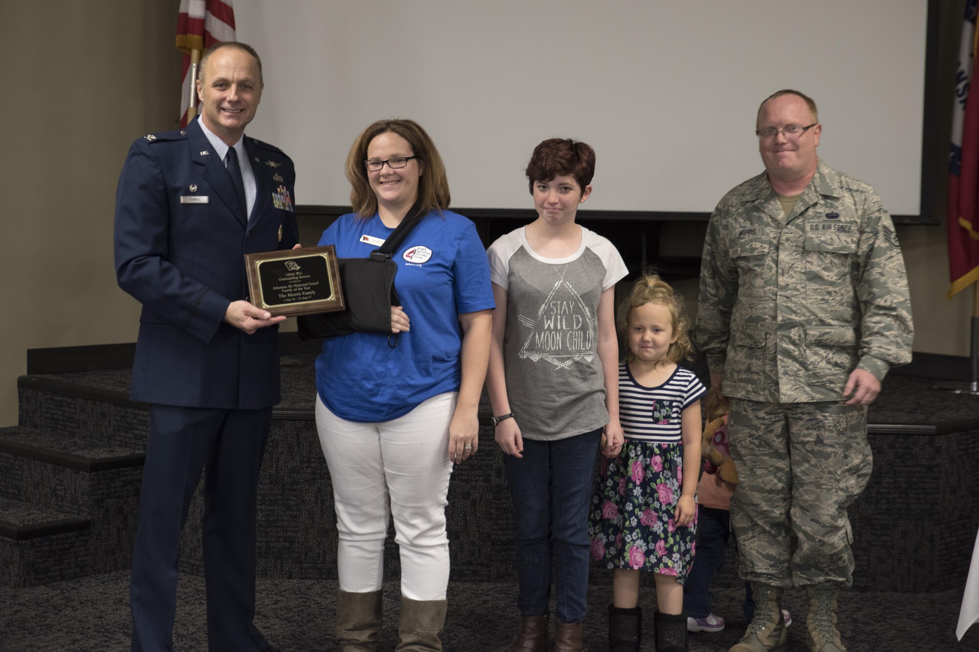 Staff Sgt. Tim Morris, and his family receive the 2017 Arkansas Air National Guard Family of the Year Award from Col. Robert Kinney, 188th Wing commander, Nov. 4, 2017, at Ebbing Air National Guard Base, Fort Smith, Ark. Morris and his family have shown outstanding and exceptional service to the family program. (U.S. Air National Guard photo by Tech. Sgt. Daniel Condit)
