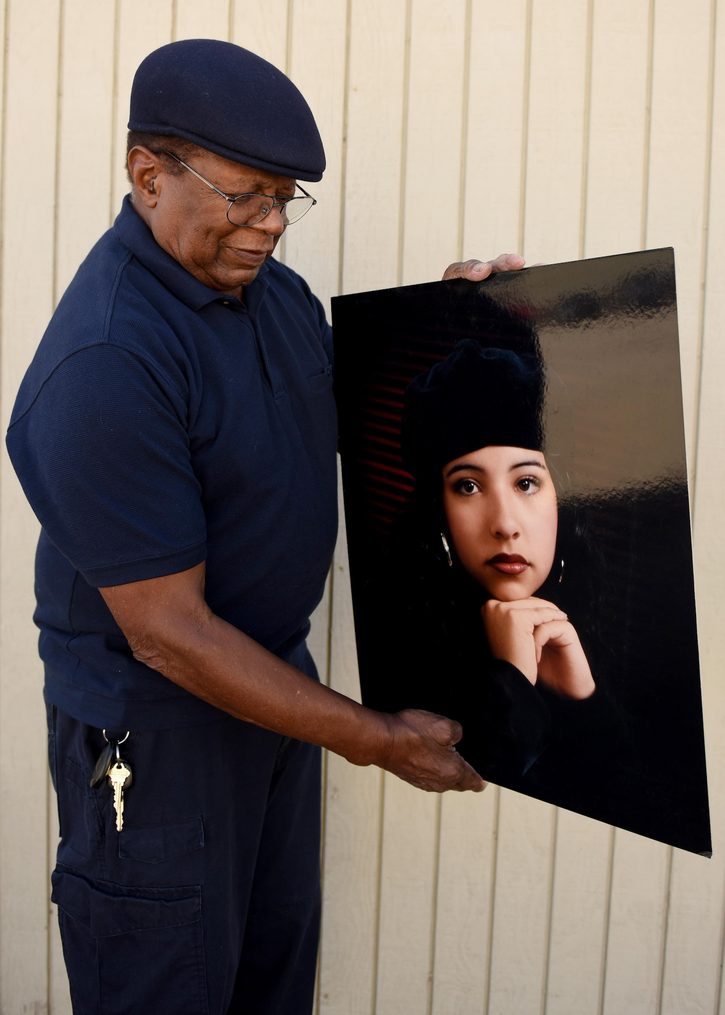 Retired U.S. Air Force Master Sgt. Clarence Rollins, ‘Rocky’, holds a portrait he photographed almost twenty years ago, Oct. 10, 2017, Vandenberg Air Force Base, Calif. Rocky owned a photography studio for 45 years, where he photographed everything from portraits, weddings, dances, and copy and restoration. (U.S. Air Force photo by Senior Airman Kyla Gifford/Released)