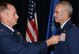 Lt. Col. Richard Pantusa, left, the 302nd Operations Group commander, pins the Meritorious Service Medal onto Lt. Col.  Luke Thompson’s service dress uniform, during Thompson’s retirement ceremony at Peterson Air Force Base, Colo. Nov. 4, 2017.