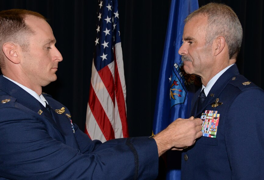 Lt. Col. Richard Pantusa, left, the 302nd Operations Group commander, pins the Meritorious Service Medal onto Lt. Col.  Luke Thompson’s service dress uniform, during Thompson’s retirement ceremony at Peterson Air Force Base, Colo. Nov. 4, 2017.