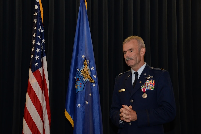 Lt. Col.  Luke Thompson, the  302nd Airlift Wing chief of aerial firefighting and command pilot, speaks to the audience during his retirement ceremony at Peterson Air Force Base, Colo. Nov. 5, 2017.