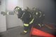 Senior Airman DeJon Peirson and Staff Sgt. Benjamin Reed, both 60th Civil Engineer Squadron firefighters, crawl through smoke in a simulated burning building on Nov. 4, 2017 at Travis Air Force Base, Calif. Airmen of the 60th CES trained on search and rescue tactics with the use of personal protective equipment and various tools.