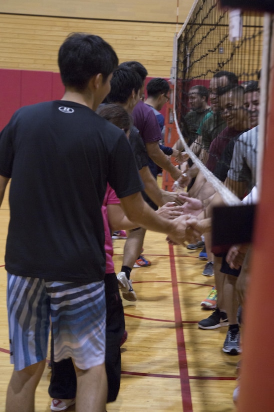 CAMP FOSTER, OKINAWA, Japan – Two teams shake hands after a game Nov. 7 at the Friendship Volleyball Event aboard Camp Foster, Okinawa, Japan.
