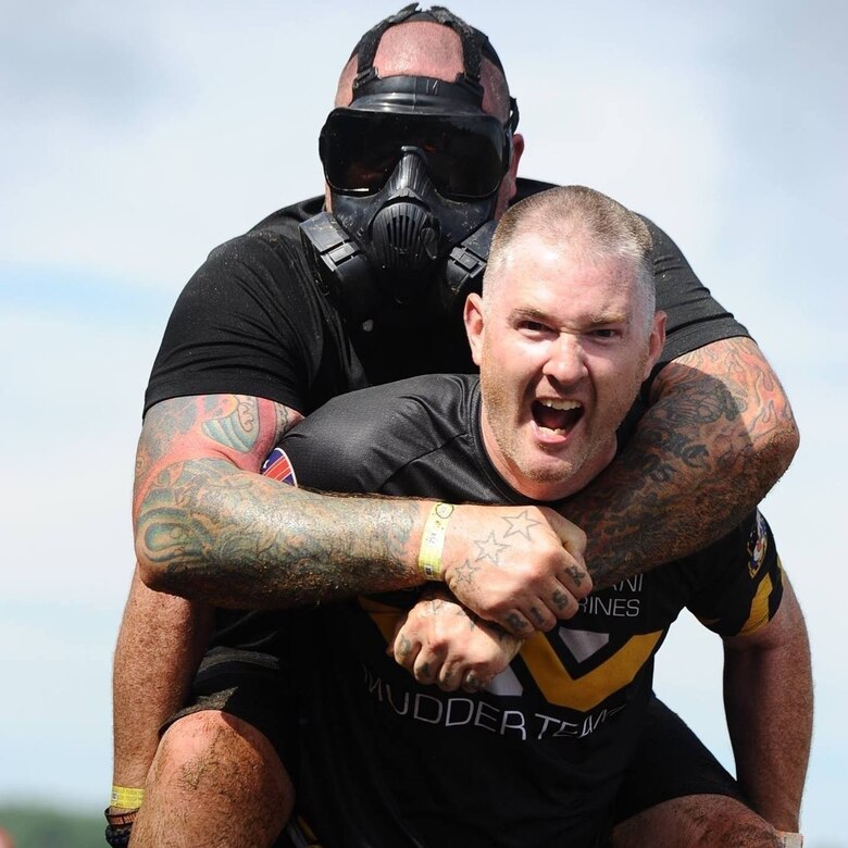 157th Air Refueling Wing's Master Sgt. Saul M. Davidson carries a teammate during a Tough Mudder Race. Davidson currently stands in fourth place in the male 40-44 year-old age group in the Tough Mudder global standings and he will be competing in the World's Toughest Mudder Race Veterans Day weekend. (Courtesy photo from Tough Mudder.)