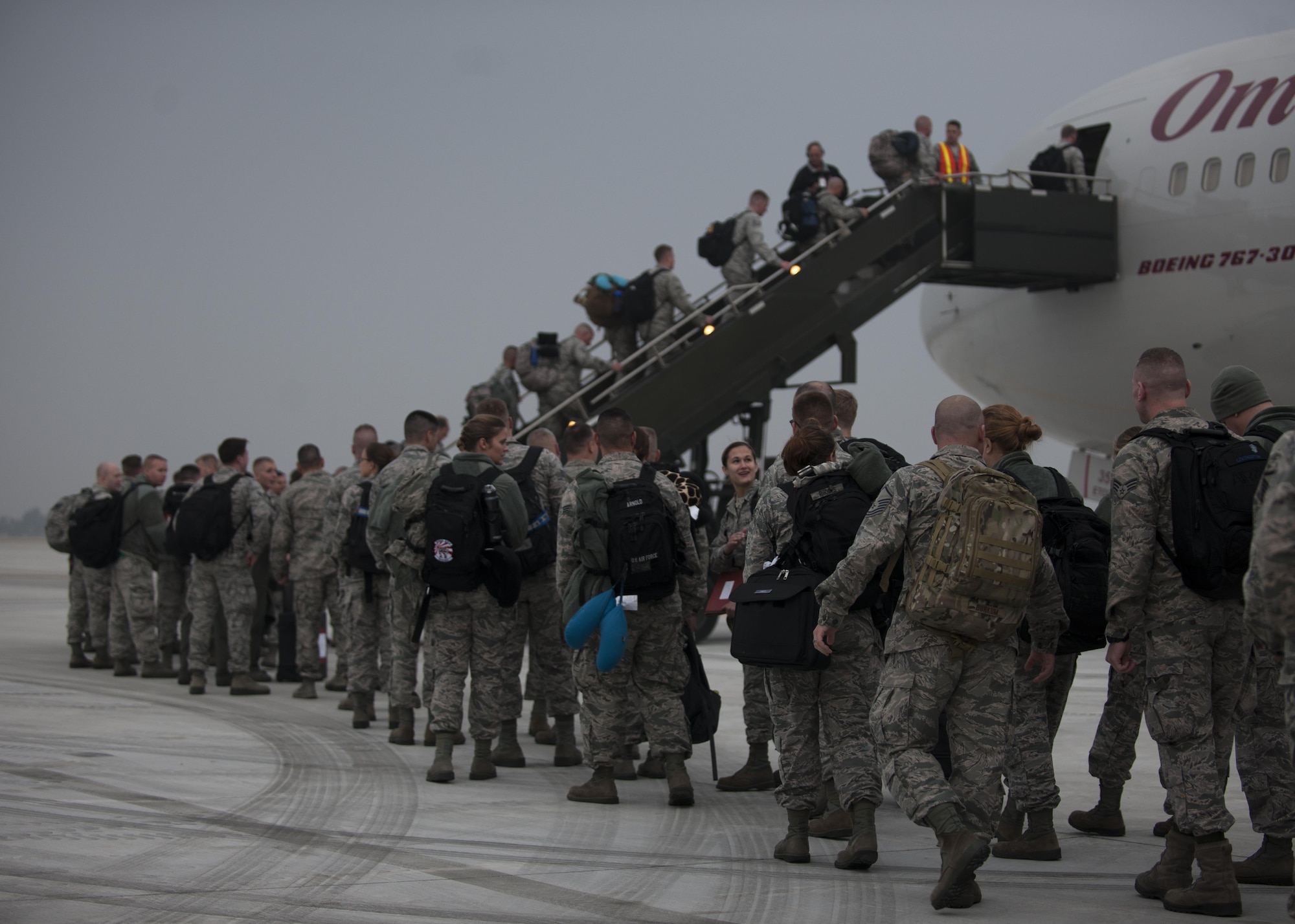 U.S. Air Force Airmen assigned to the Wisconsin Air National Guard 115th Fighter Wing, board their flight home as they prepare to depart the installation at Kunsan Air Base, Republic of Korea, Nov. 8, 2017.  The 115th FW participated in a three-month Theater Security Package rotational Deployment to Kunsan AB as part of maintaining peace and security in the Indo-Asia-Pacific region. (U.S. Air Force photo by Staff Sgt. Victoria H. Taylor)