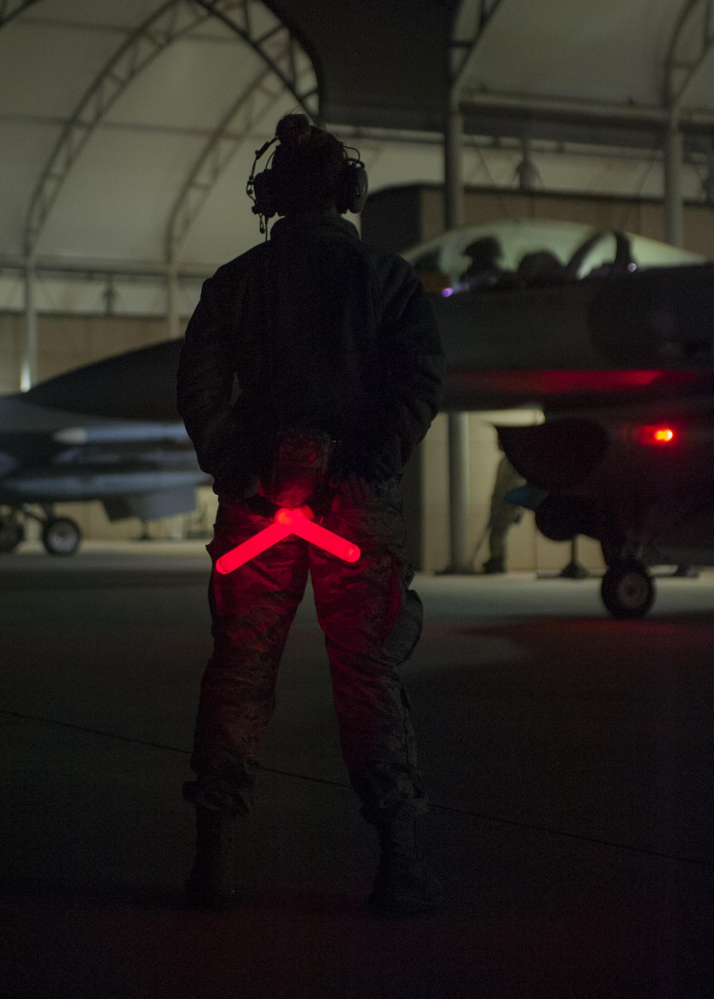 An Airman with the Wisconsin Air National Guard’s115th Fighter Wing awaits the signal from her pilot to marshal their F-16 Fighting Falcon onto the taxiway at Kunsan Air Base, Republic of Korea, Nov. 4, 2017. The aircraft departed early in the morning for their journey back to Wisconsin after a three month deployment in support of a U.S. Pacific Command Theater Security Package. (U.S. Air Force photo by Capt. Christopher Mesnard)