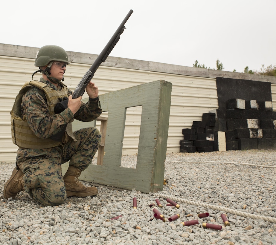 Pfc. Joseph Falletta, student, Basic Security Guard Course 2-18, (BSG), Training Co., U.S. Marine Corps Security Forces Regiment, loads a shotgun while kneeling behind a barrier on training day 2 at Naval Support Activity Northwest Annex, Chesapeake, Va., Nov. 7.
Marines were required to demonstrate they could quickly shoot, move and reload their weapons under intense stress in order to pass the shotgun range portion of the course. (Official U.S. Marine Corps photo by Chris Jones/Released)