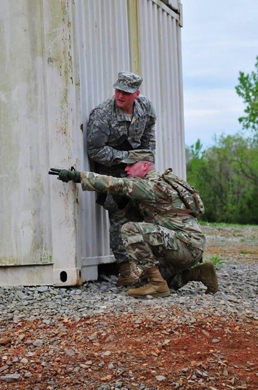 Soldiers take cover behind a shipping container