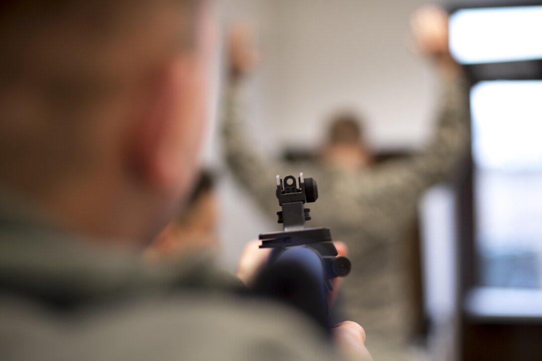 A U.S. Air Force Airman detains an Airman with a training rifle during a Selectively Trained And Ready simulation at the 86th Security Forces Squadron training facility on Ramstein Air Base, Germany, Nov. 7, 2017. The simulation instructs STAR augmentees when to use lethal force and when not to. (U.S. Air Force photo by Senior Airman Devin Boyer)