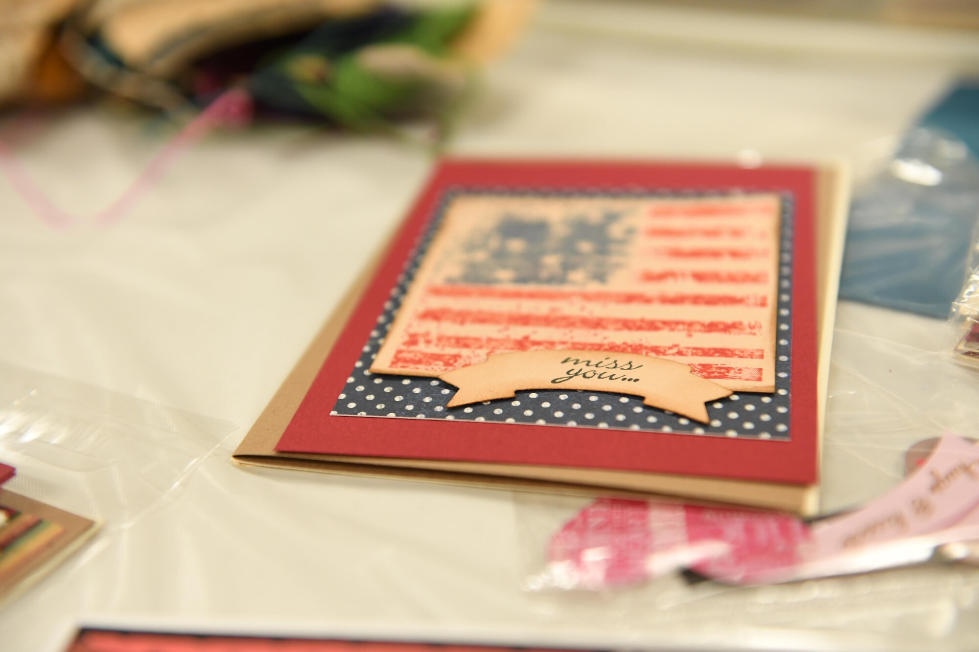 A red, white and blue greeting card sits on a table at the Pittsburgh International Airport Air Reserve Station, Pa., November 5th, 2017. This was just one of the types of cards available for family members to make for their deployed service members, an opportunity hosted by the 911th Logistics Readiness Squadron. (U.S. Air Force photo by Senior Airman Beth Kobily)