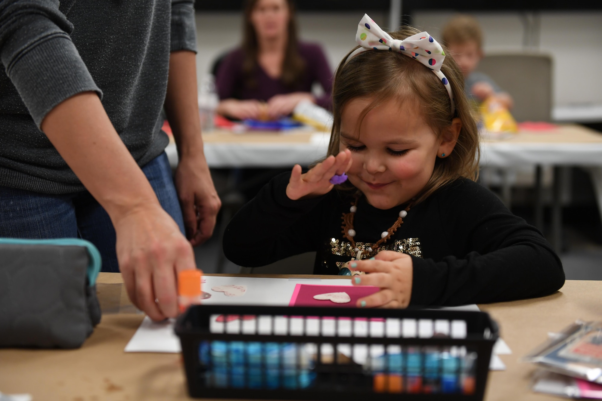 A young girl puts the finishing touches on a greeting card at the Pittsburgh International Airport Air Reserve Station, Pa., November 5th, 2017. This was part of an effort by the 911th Logistics Readiness Squadron to give families the opportunity to create greeting cards for deployed loved ones. (U.S. Air Force photo by Senior Airman Beth Kobily)