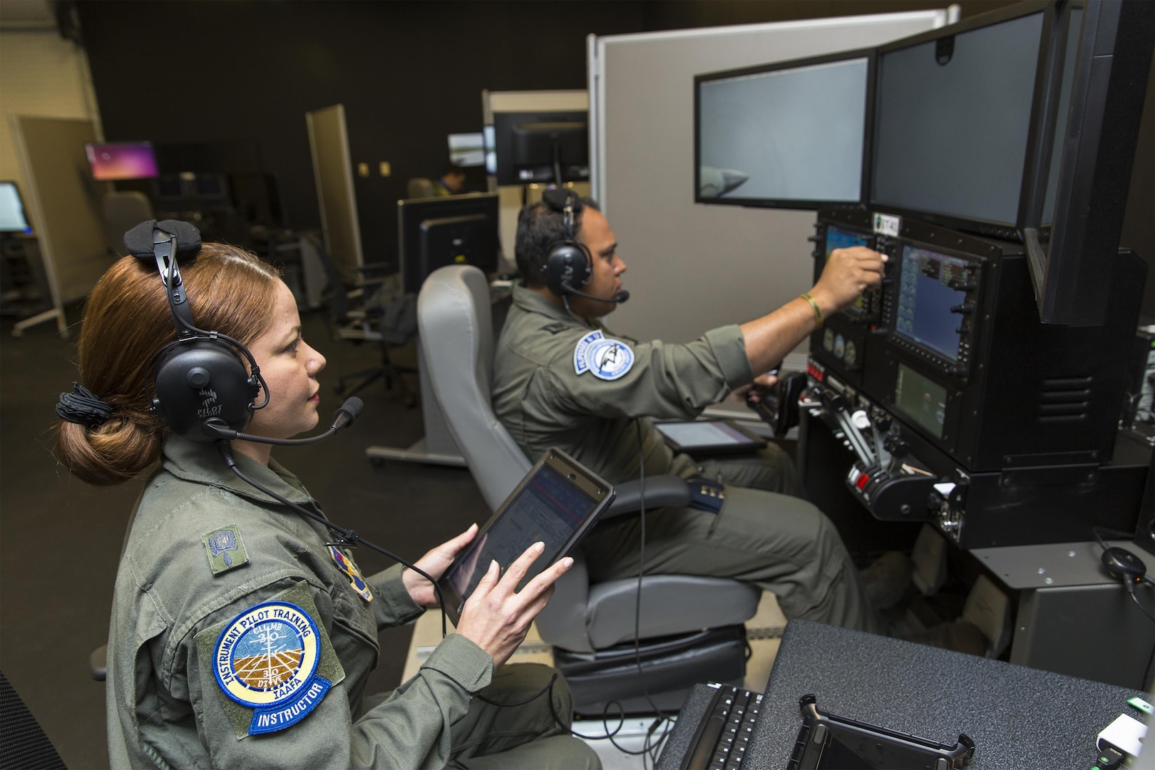 Maj. Maria Tejada-Quintana (left), a guest instructor at the Inter-American Air Forces Academy at Joint Base San Antonio-Lackland, oversees a student's flight simulation Oct 3, 2017. Tejada-Quintana is the only female flight guest instructor teaching international students from partner nations in the Western Hemisphere.