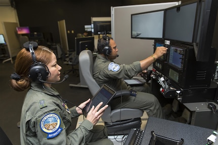 Maj. Maria Tejada-Quintana (left), a guest instructor at the Inter-American Air Forces Academy at Joint Base San Antonio-Lackland, oversees a student's flight simulation Oct 3, 2017. Tejada-Quintana is the only female flight guest instructor teaching international students from partner nations in the Western Hemisphere.