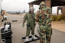 U.S. Air Force Reserve Master Sgt. Ronald Johnson, aircrew flight equipment (AFE) supervisor, 913th Operations Support Squadron, sprays a simulated 5% chlorine solution on Lt. Col. Keith Jasmin, pilot, 327th Airlift Squadron, in the Aircrew Contamination Control Area Nov. 4, 2017, at Little Rock Air Force Base, Ark.
