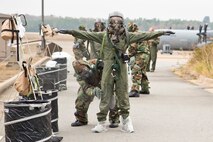 A U.S. Air Force Reserve aircrew member assigned to the 327th Operations Support Squadron, is pat down with activated charcoal from a M295 Individual Decontamination Kit during a training scenario Nov. 4, 2017, at Little Rock Air Force Base, Ark.