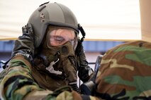U.S. Air Force Reserve Senior Airman Joshua Pirtle, aircrew flight equipment (AFE) specialist, 913th Operations Support Squadron, takes a helmet off of Senior Airman Jonathan Haskett, a loadmaster assigned to the 327th Airlift Squadron, during “Ability to Survive and Operate” (ATSO) training Nov. 4, 2017, at Little Rock Air Force Base, Ark.